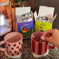 Brewing two cups of Cozy Moon tea on a kitchen counter
