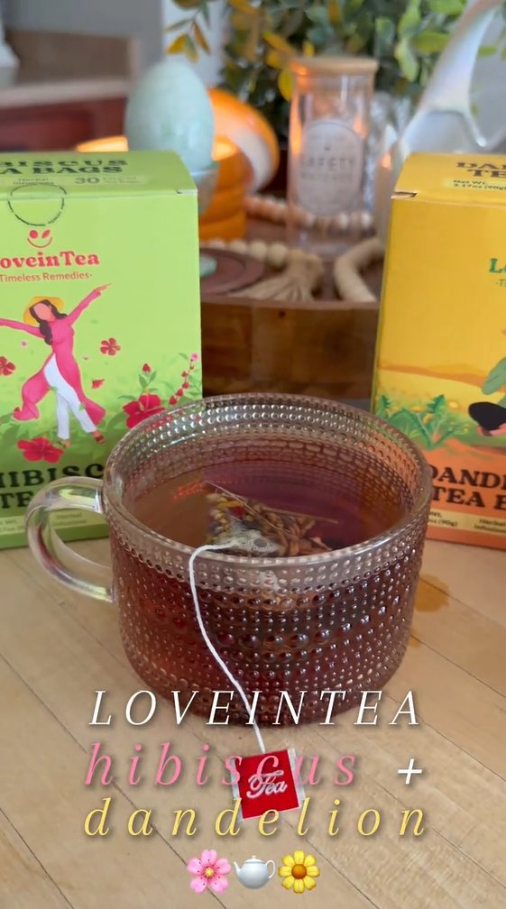 Glass mug of hibiscus tea with Hibiscus and Dandelion boxes